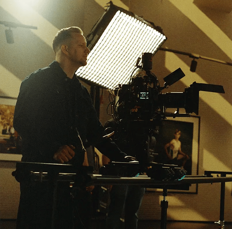 A cinematographer operates a RED cinema camera on a virtual production film set