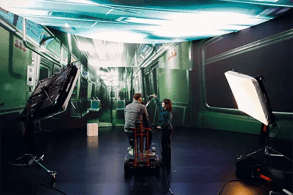A cinematographer and camera operator operate a RED Cinema Camera on a doorway dolly durin g a virtual production shoot