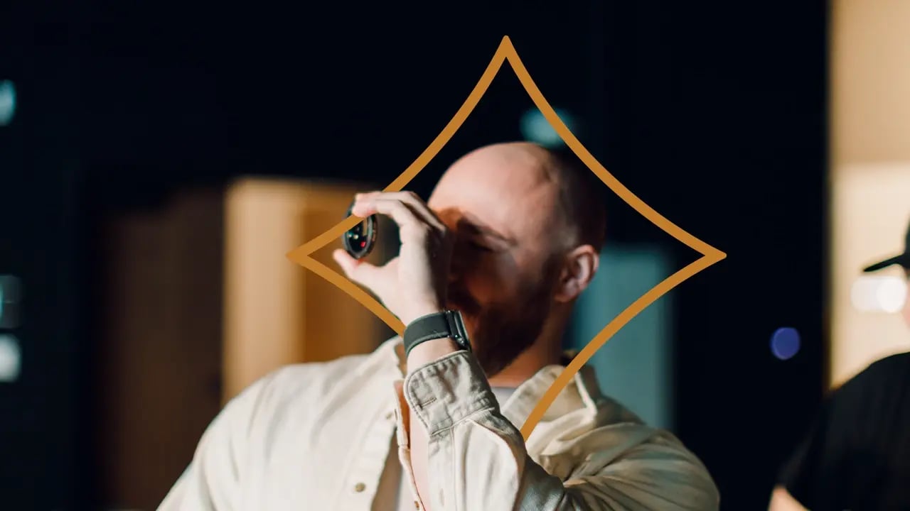 Cinematographer inspecting a cinema lens back element