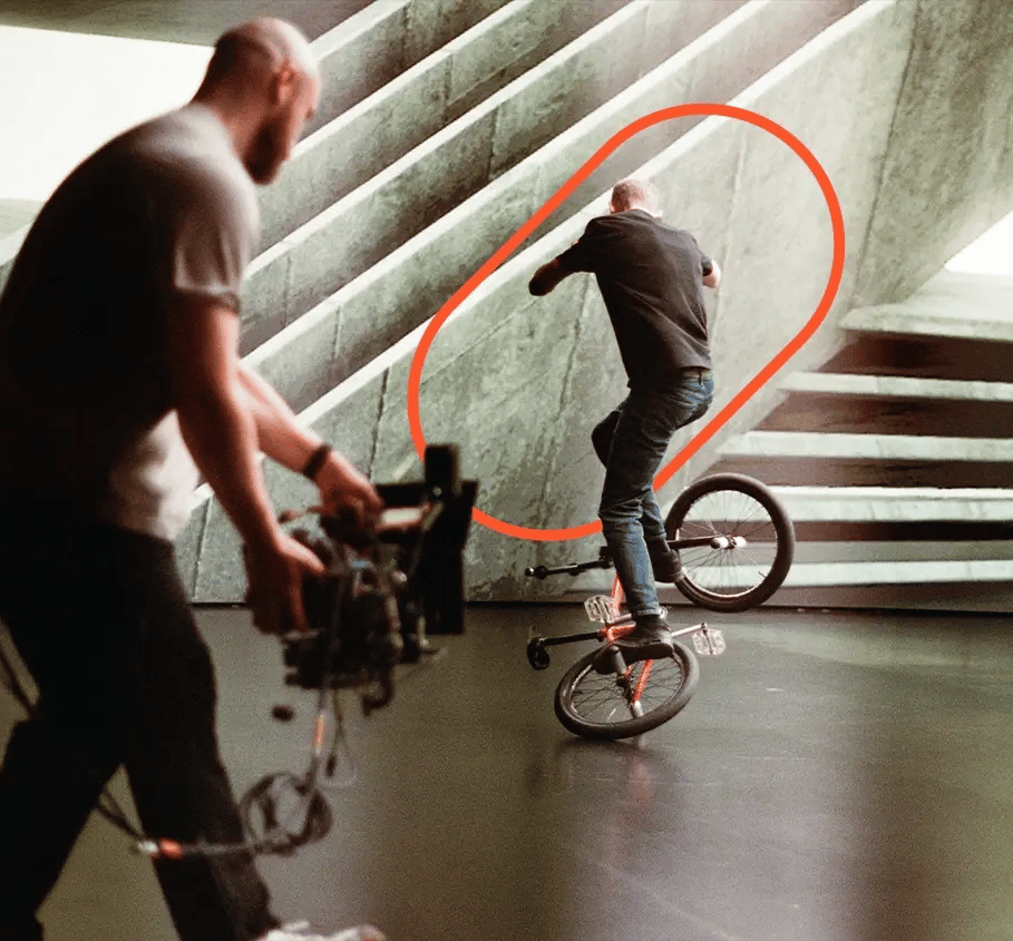 A BMX Biker does a trick for a cinematographer filming it on RED cinema camera at an LED virtual production studio