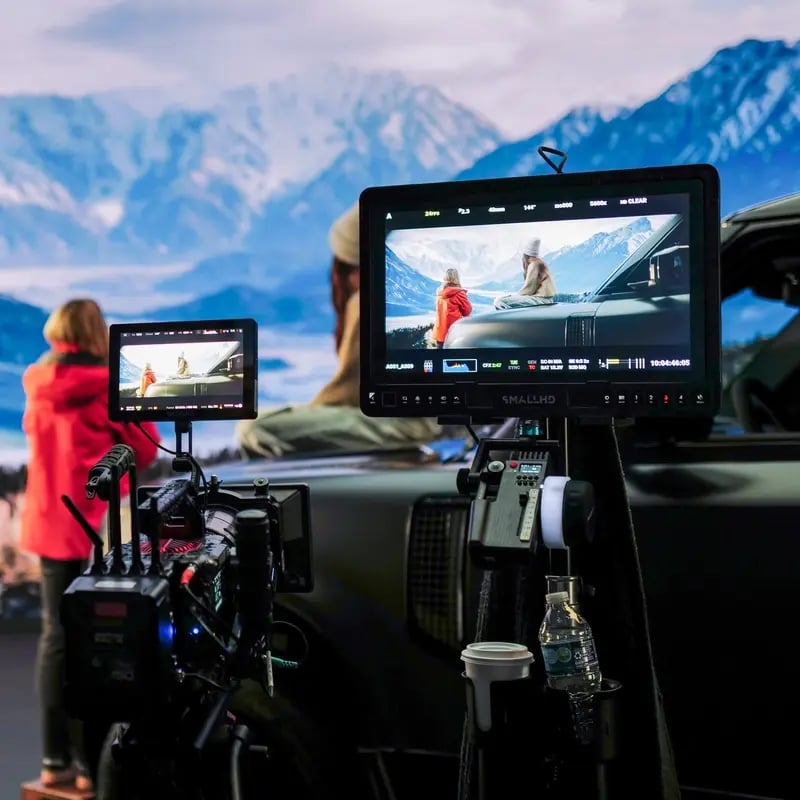 Camera shooting scene in front of mountains screen