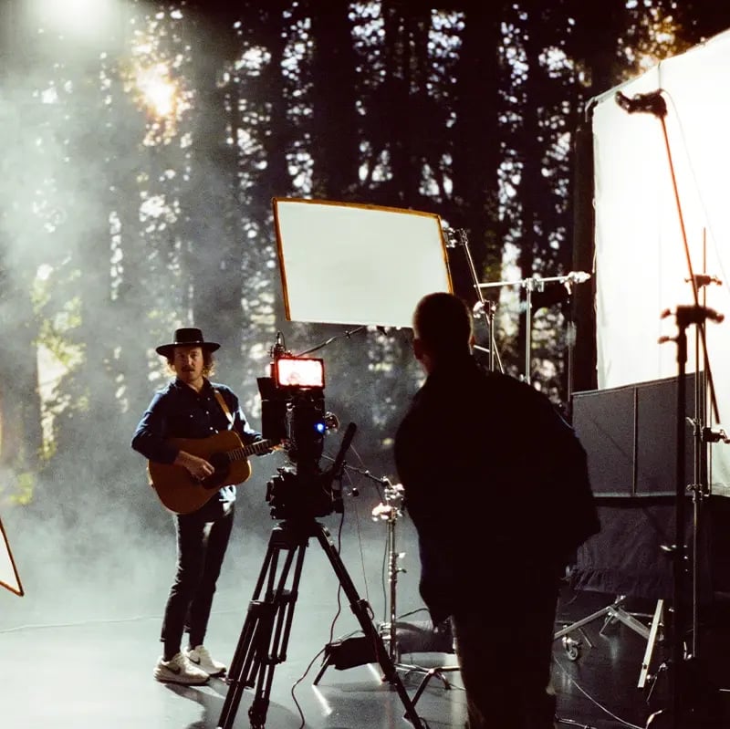 A guitarist performs in front of an LED virtual production wall
