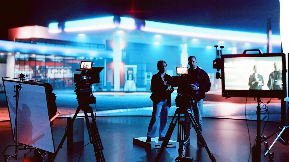 A producer and director stand on set in a virtual production LED wall stage