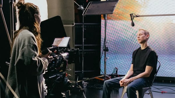 A documentary subject is interviewed on an LED virtual production wall 