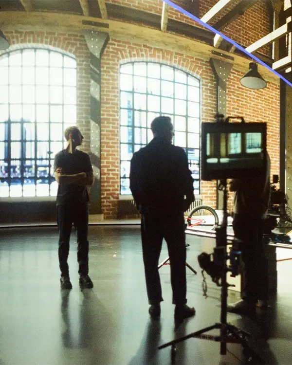 A film crew sets up a shot on an LED virtual production stage using Unreal Engine environments