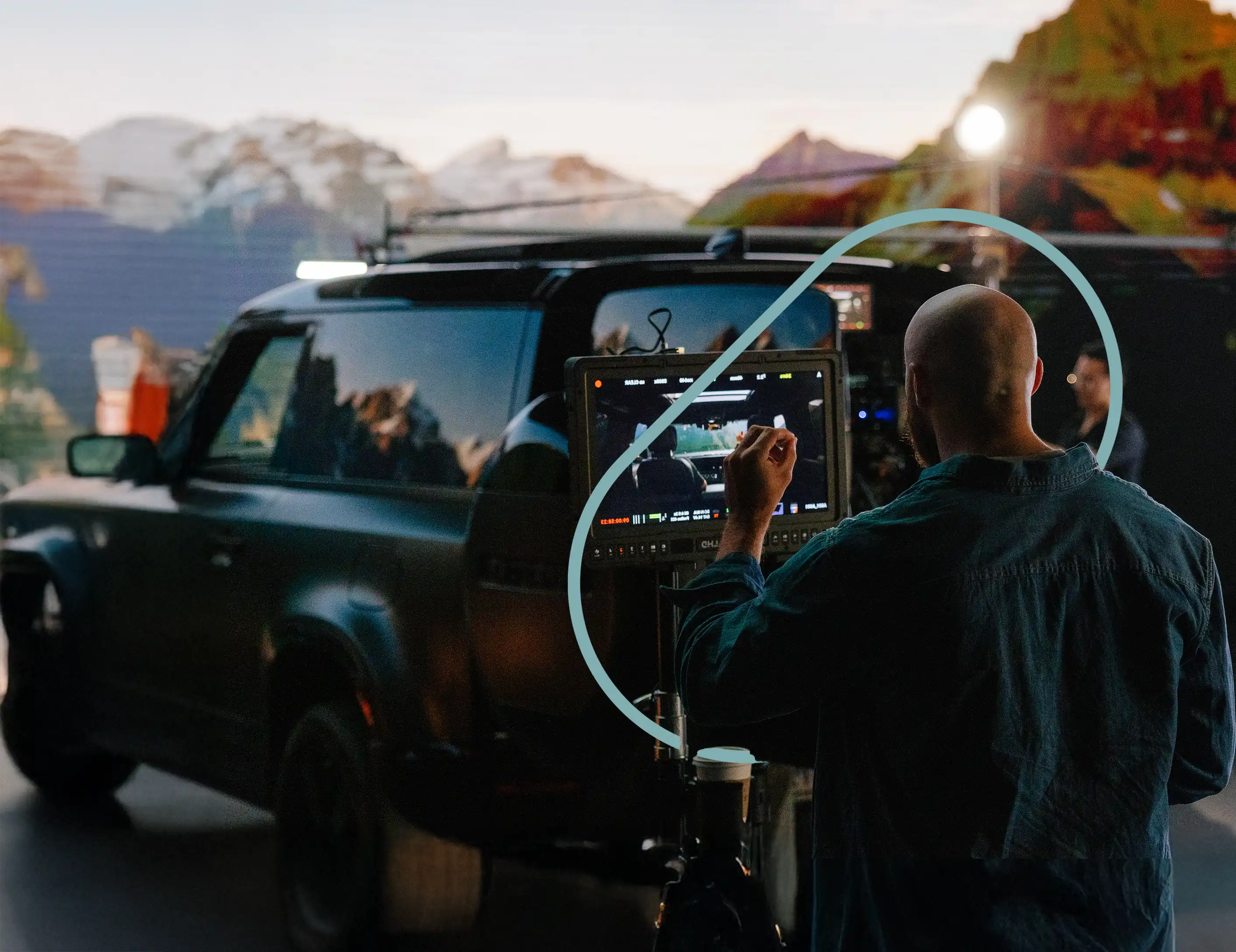 A Cinematographer is reviewing the shot of a car on a virtual production stage
