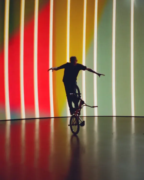 A BMX biker performs a trick in front of an LED virtual production wall