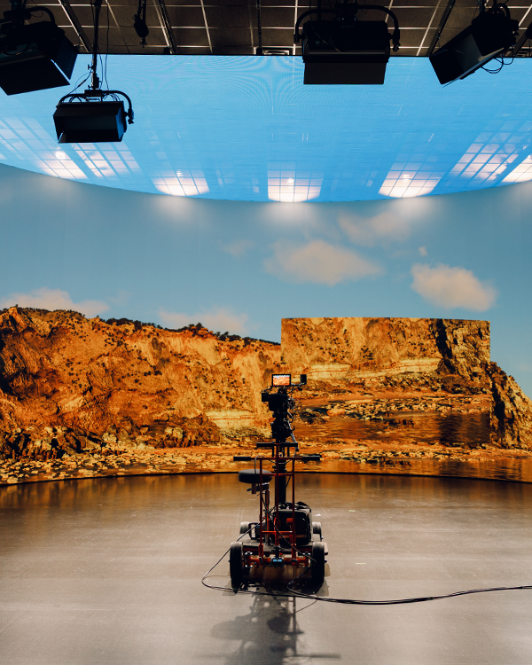 A camera mounted to a dolly, sitting in front of a virtual production LED wall