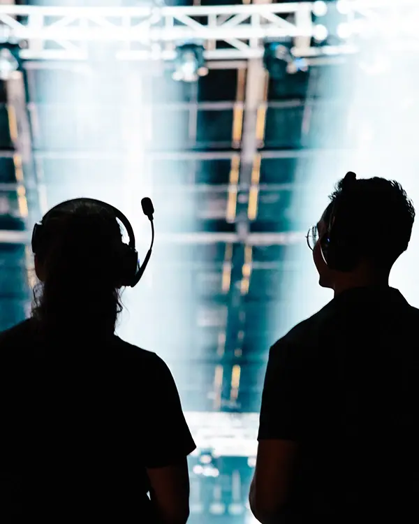 a grip and electric crew stands in front of an led wall